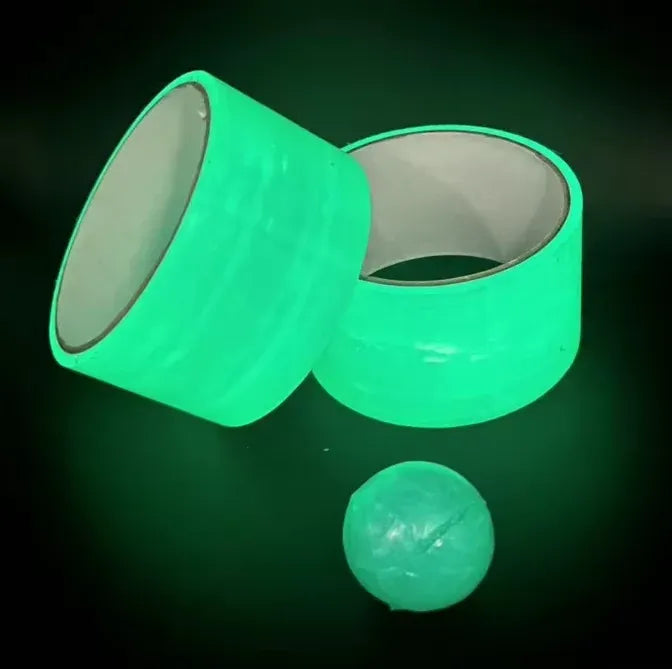 Two neon green glow tape rolls with a glowing green slime ball nearby