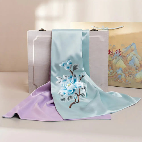 Luxury long silk scarf in aqua and lavender with intricate blue floral peony embroidery and elegant satin finish.
