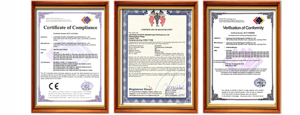 Three product compliance and registration certificates in brown wooden frames for a heating mattress.