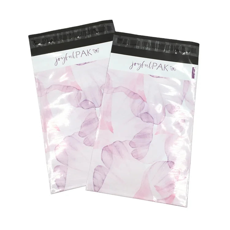 Two pink translucent poly mailer bags with pastel floral pattern and black joyfulPAK header