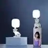 White square clip-on LED fill light for mobile phones, used for improved lighting in photos and videos.