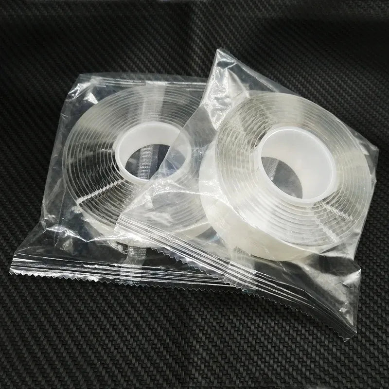 White double-sided nano tape roll in clear plastic wrap, two coils side by side