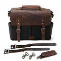 Retro motorcycle saddle bag in black oil wax canvas and brown crazy horse leather with straps and metal hardware.