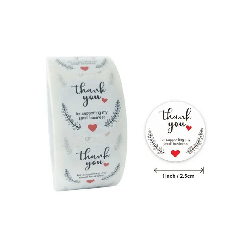 Thank-you sticker roll, white with blue laurel wreath, hearts, and “Thank you” lettering