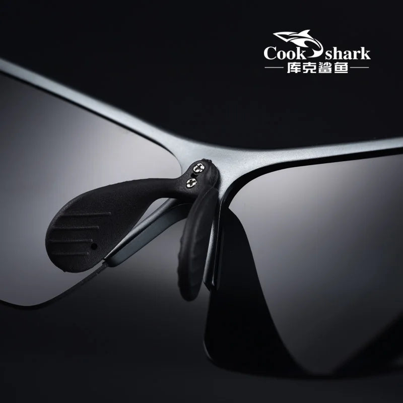 Close-up of black rimless polarized sunglasses with metallic frames and textured black rubber nose pads.