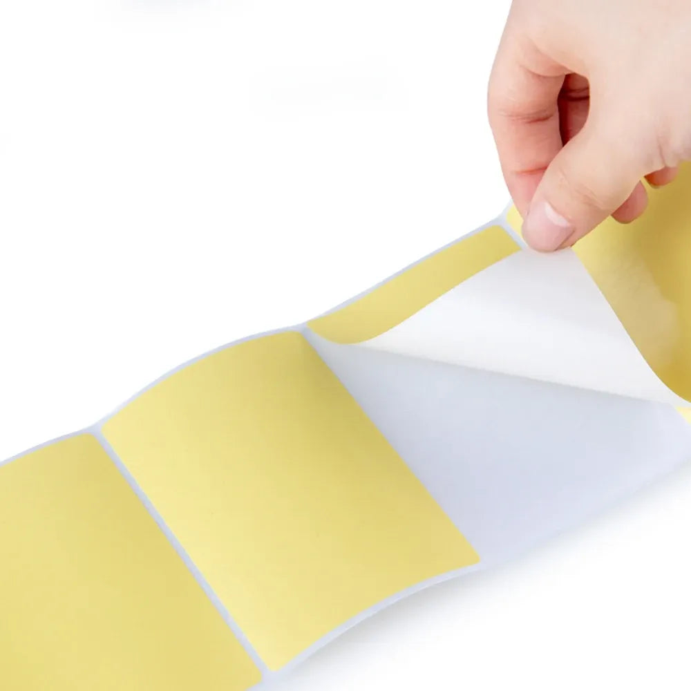 Hand applying yellow waterproof label stickers with rectangular printed panels