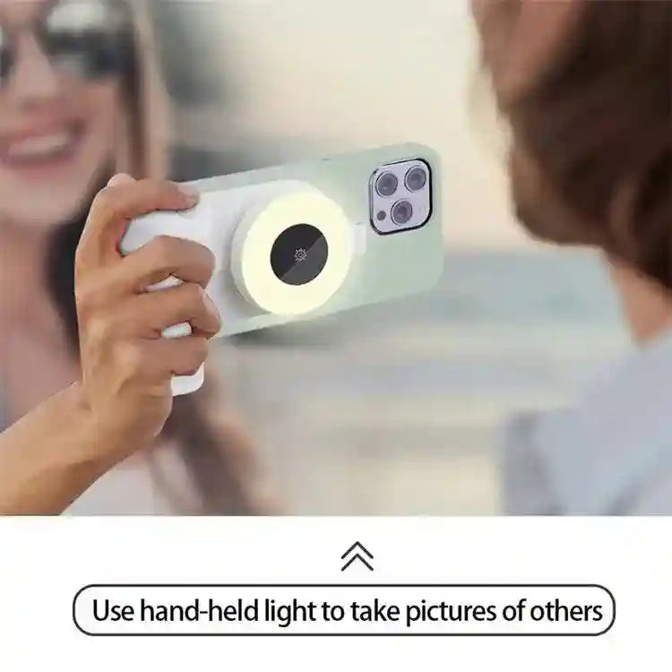 Magnetic ring light attached to a sage green phone case, used as a grip for taking photos.