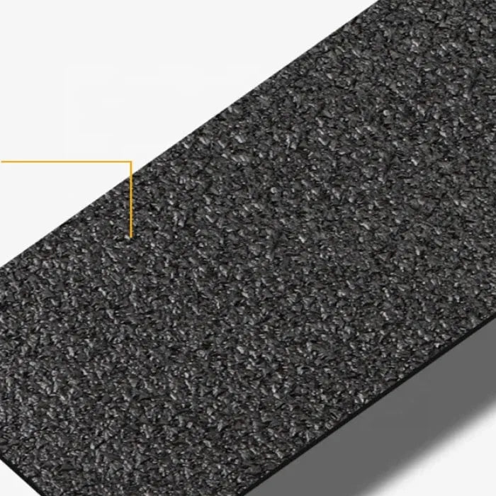 Close-up of black anti-slip tape texture with fine granular grip surface