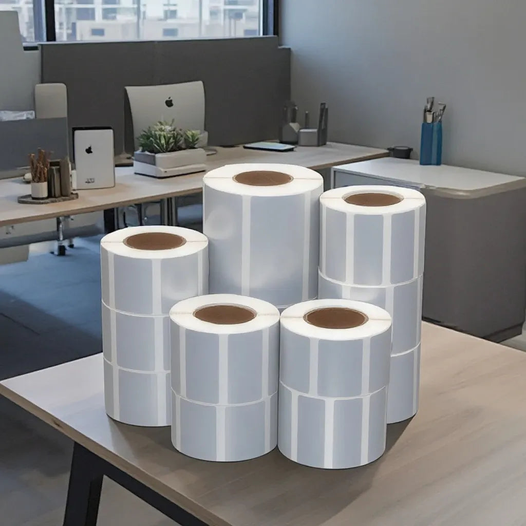 Stack of matte silver thermal label rolls, self-adhesive rectangular label stickers