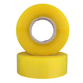Stacked yellow packing tape rolls with clear inner cores for sealing cartons