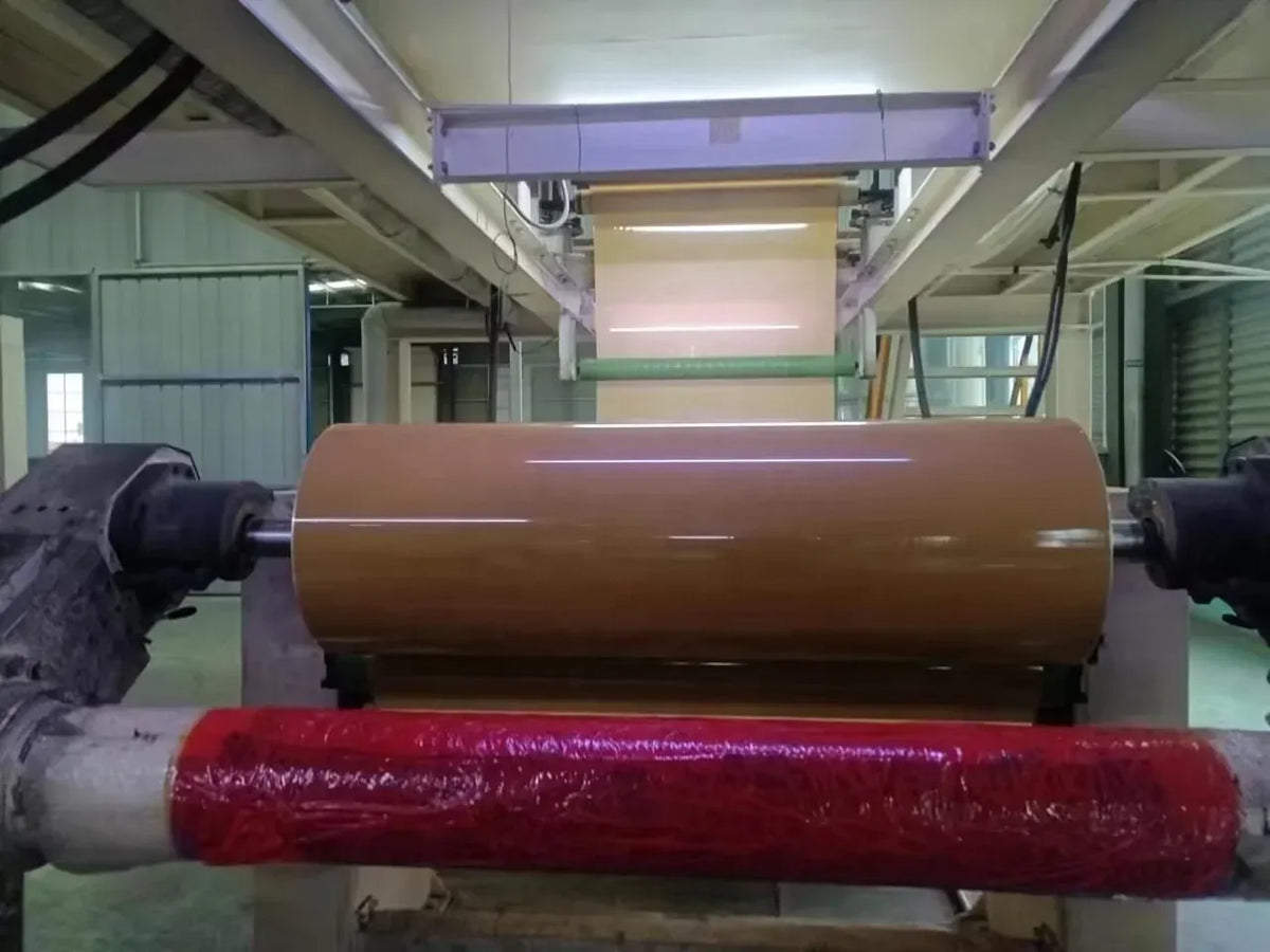 Clear BOPP tape jumbo roll mounted on processing machine rollers