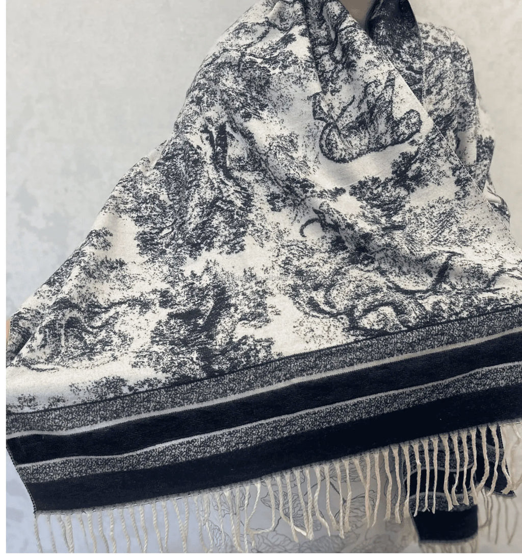Luxury black and white toile de jouy print silk scarf with striped border and fringe trim, rectangular shape.