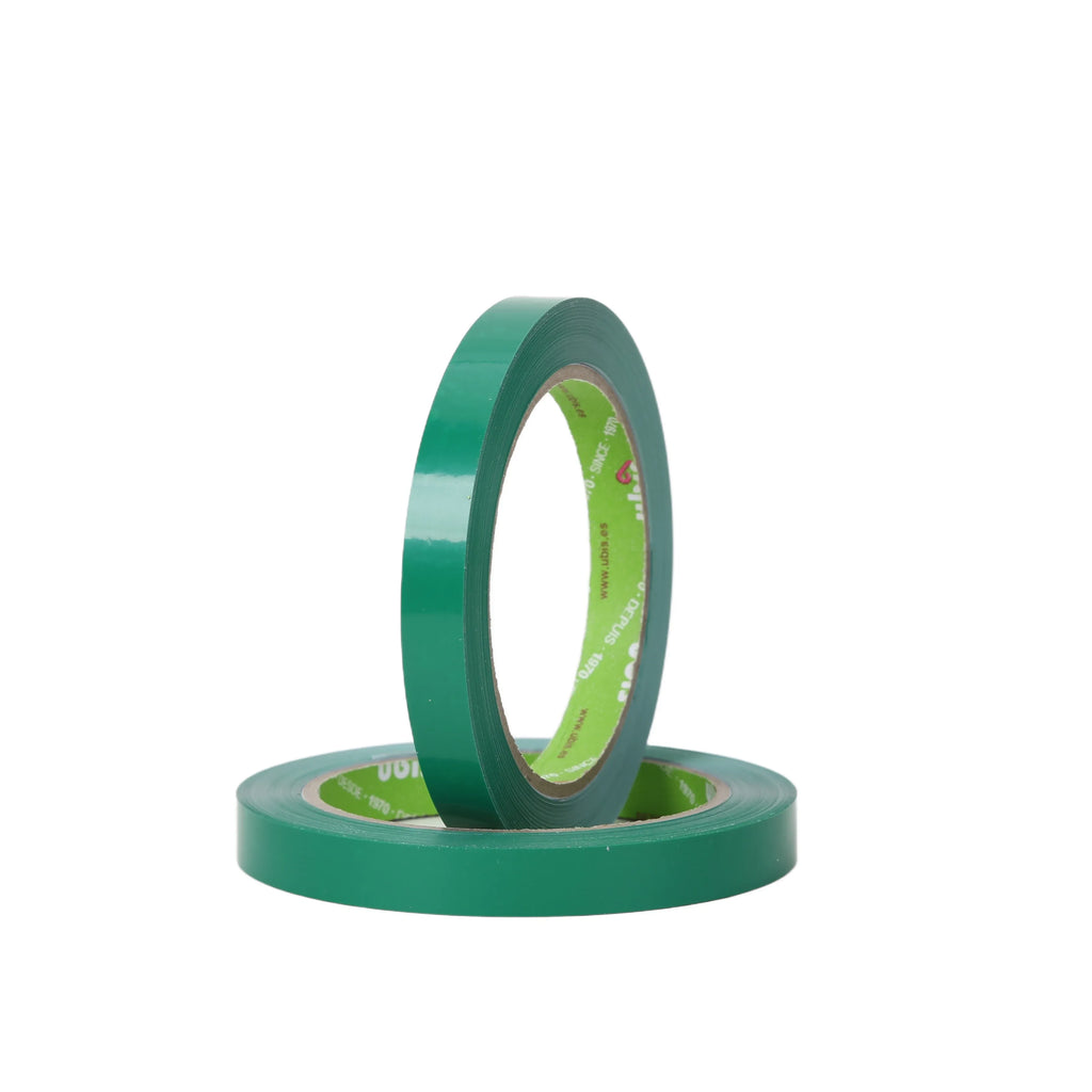 Green PVC single-sided adhesive tape roll standing with visible printed inner core