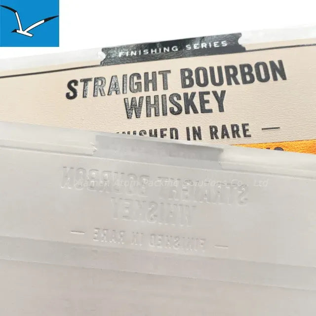 Close-up of waterproof vinyl label reading “STRAIGHT BOURBON WHISKEY” with finishing series