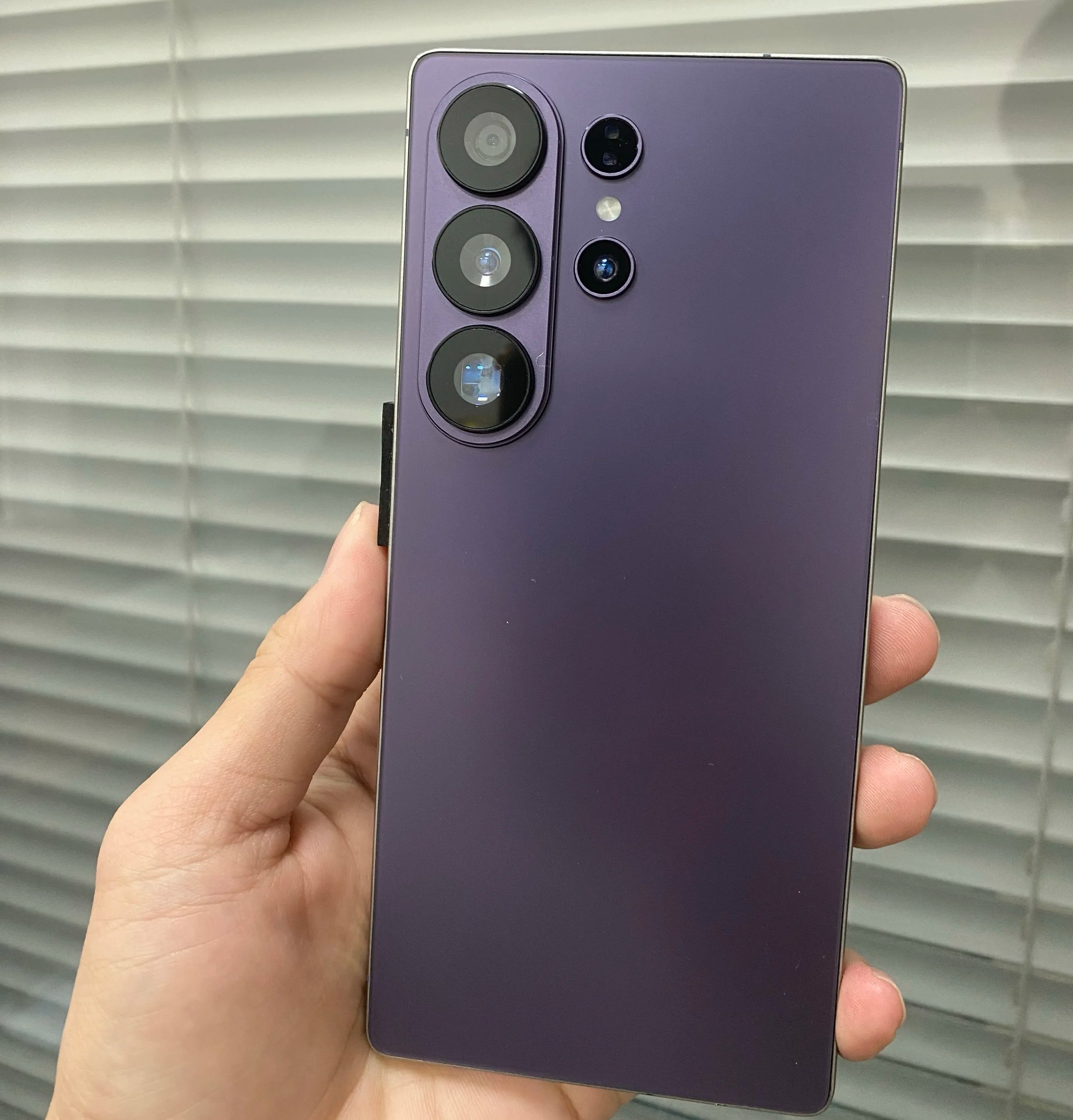 Close-up of S26 Ultra smartphone showing premium metallic frame, precise button placement, and charging port detail.
