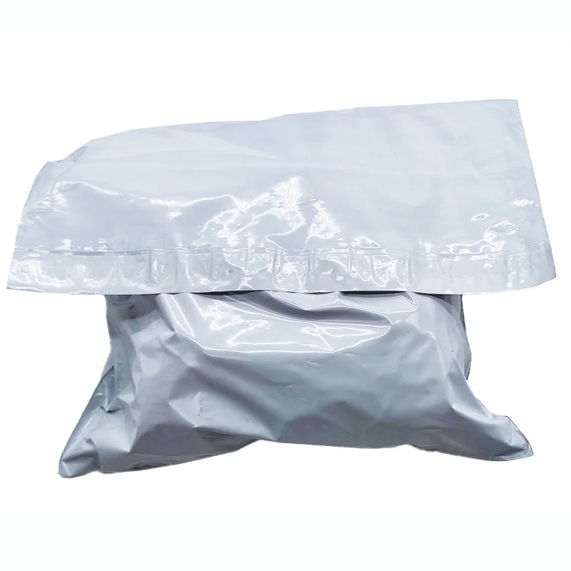 Light blue-gray heat-sealed poly mailer shipping bag, crumpled folded lay-flat