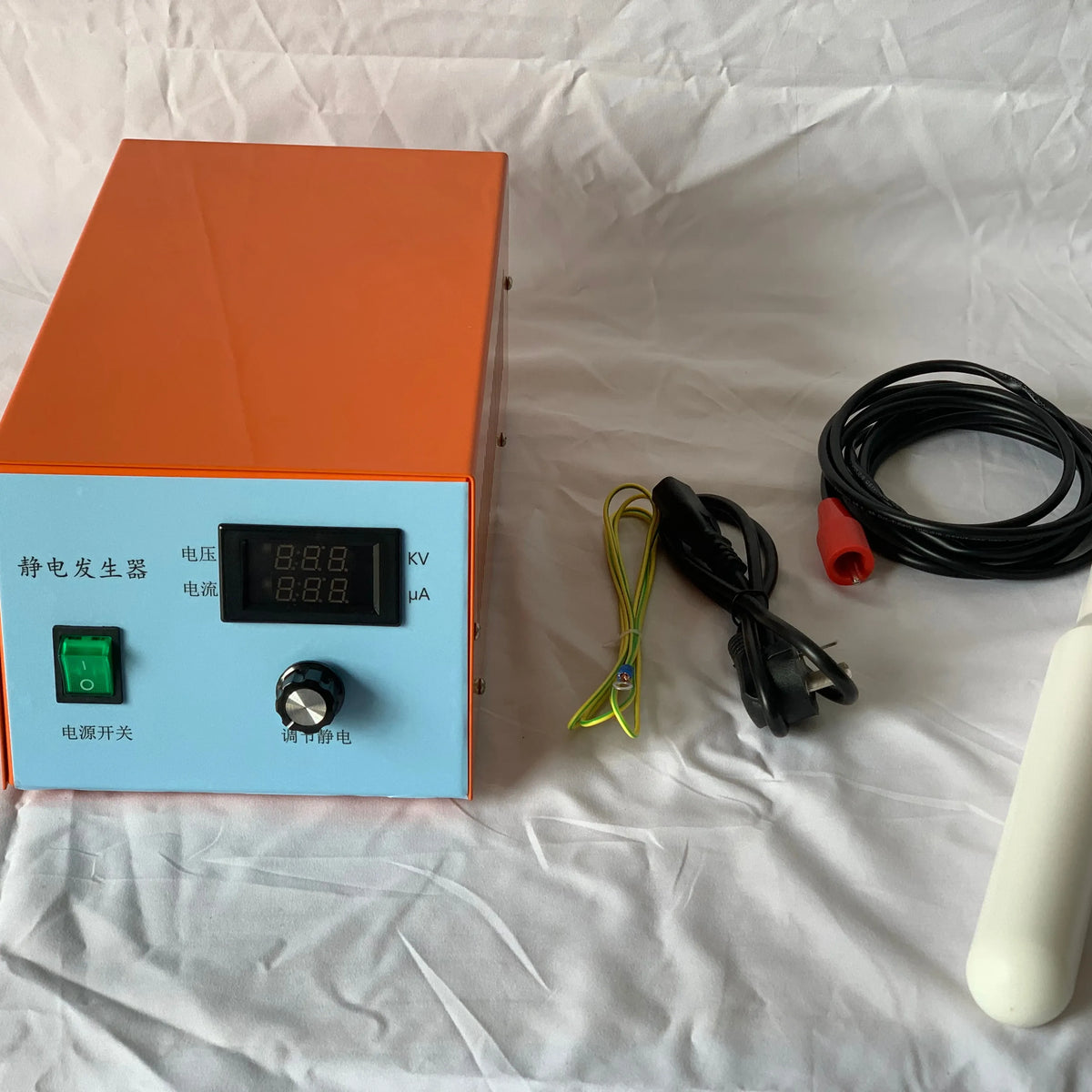 Static charge generator with orange-and-blue control box and attached ionizing rod, cables