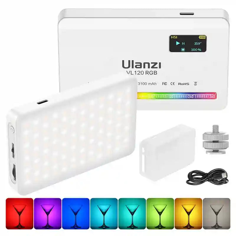 White portable rectangular RGB LED video light with digital display, silicone diffuser, cold shoe mount, and USB cable.