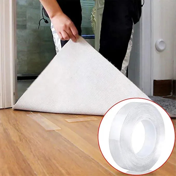 White mounting tape used under a folded rug or mat on a wooden floor