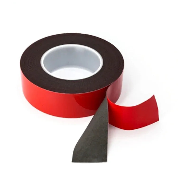 Red and dark double-sided acrylic foam tape roll with cut adhesive strip