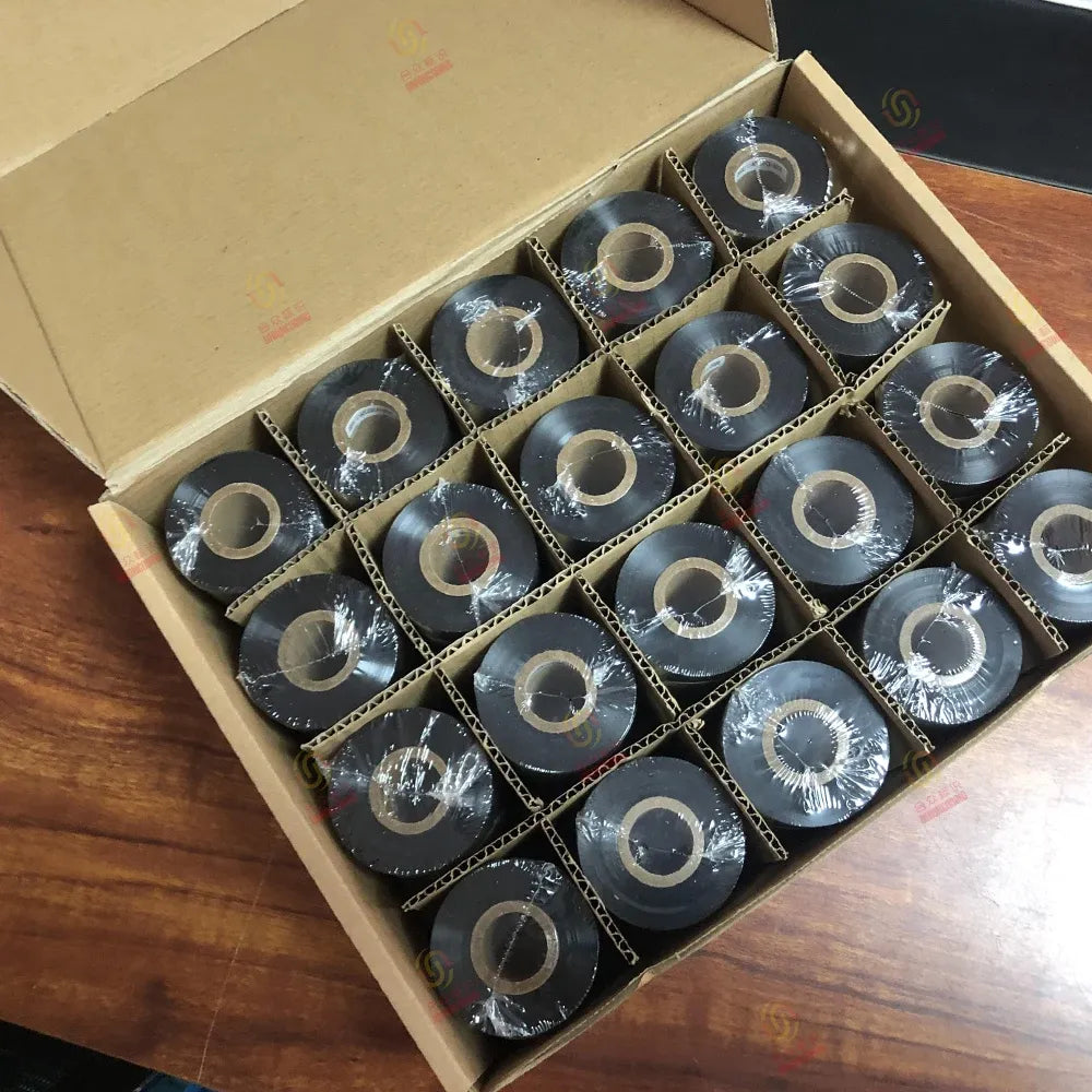 Box of black thermal barcode ribbon spools with shiny foil edges