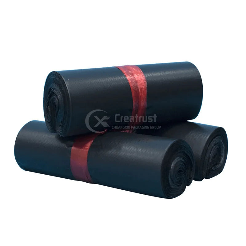 Rolled dark blue plastic poly mailer bags with red tie band