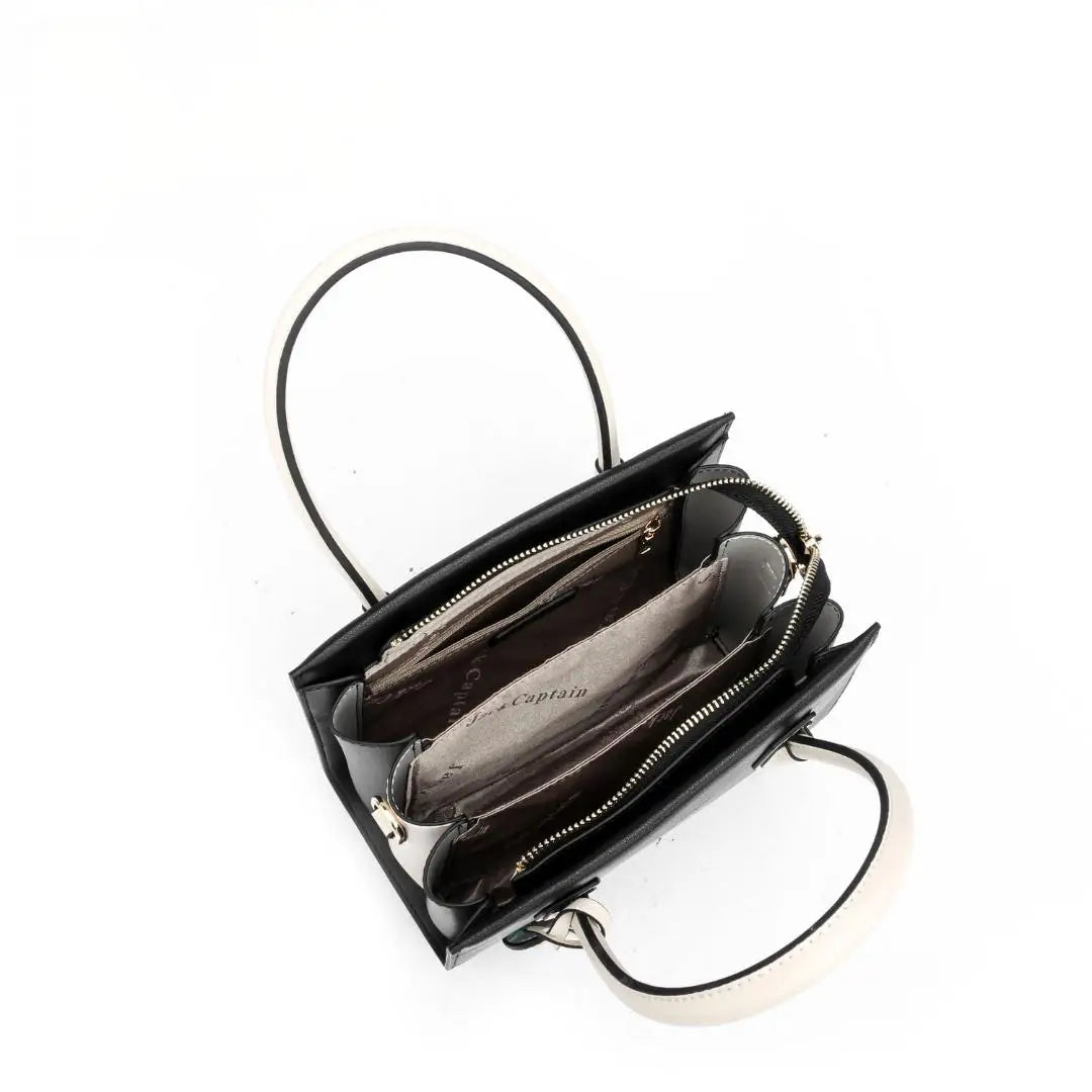 Jack Captain designer tote in black genuine leather with contrasting white handles and zippered polyester lining.