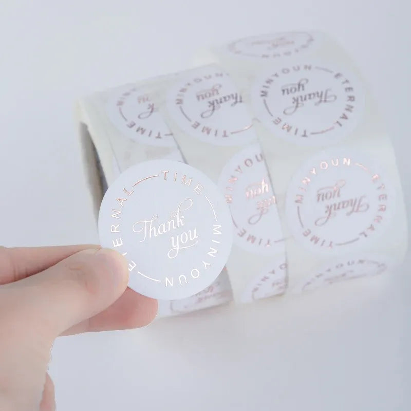 Thank-you circular label stickers with red script on clear backing sheet