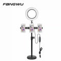 Black adjustable stand with a circular LED ring light and three smartphone holders for mobile content creation.