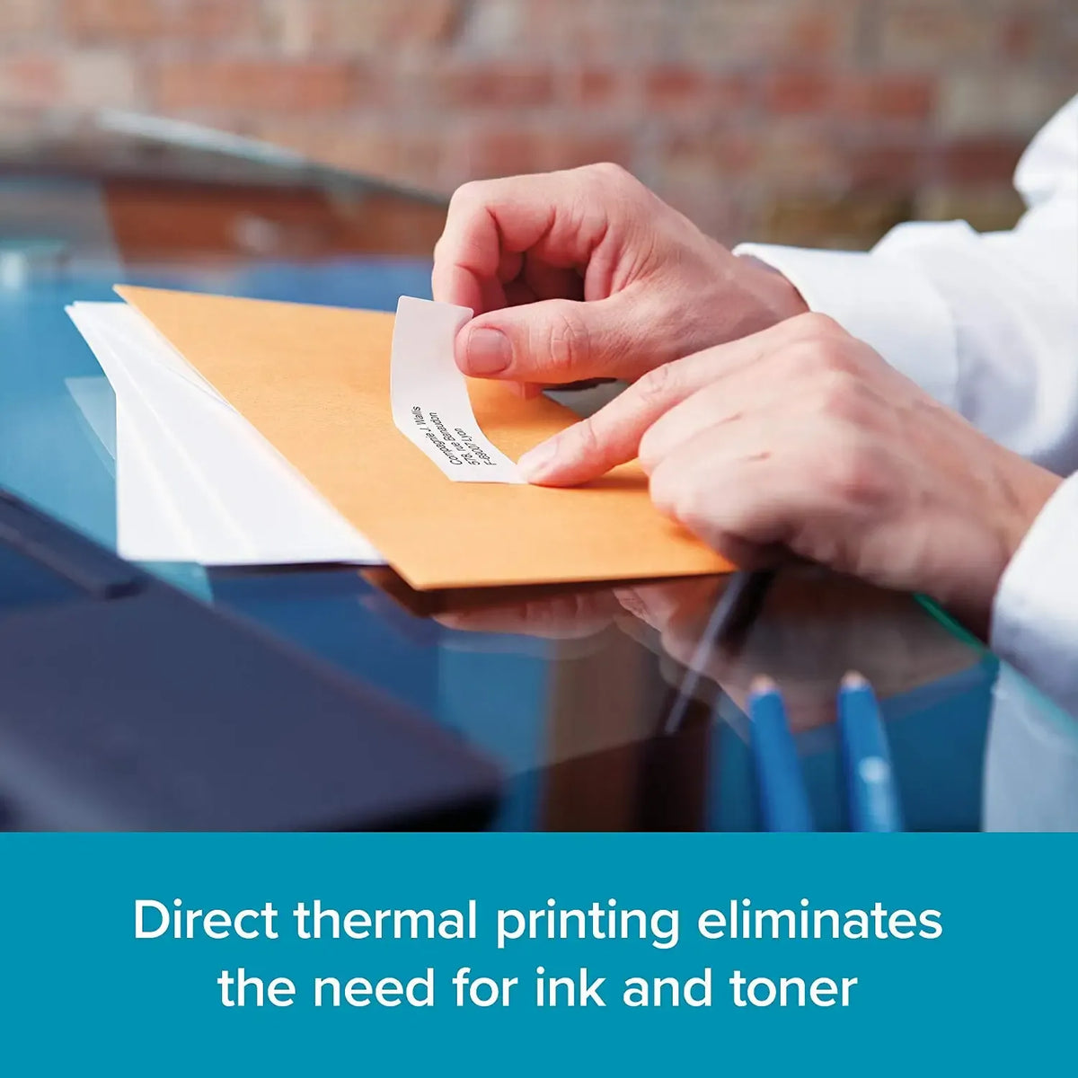 Hand applying white address label to envelope for shipping
