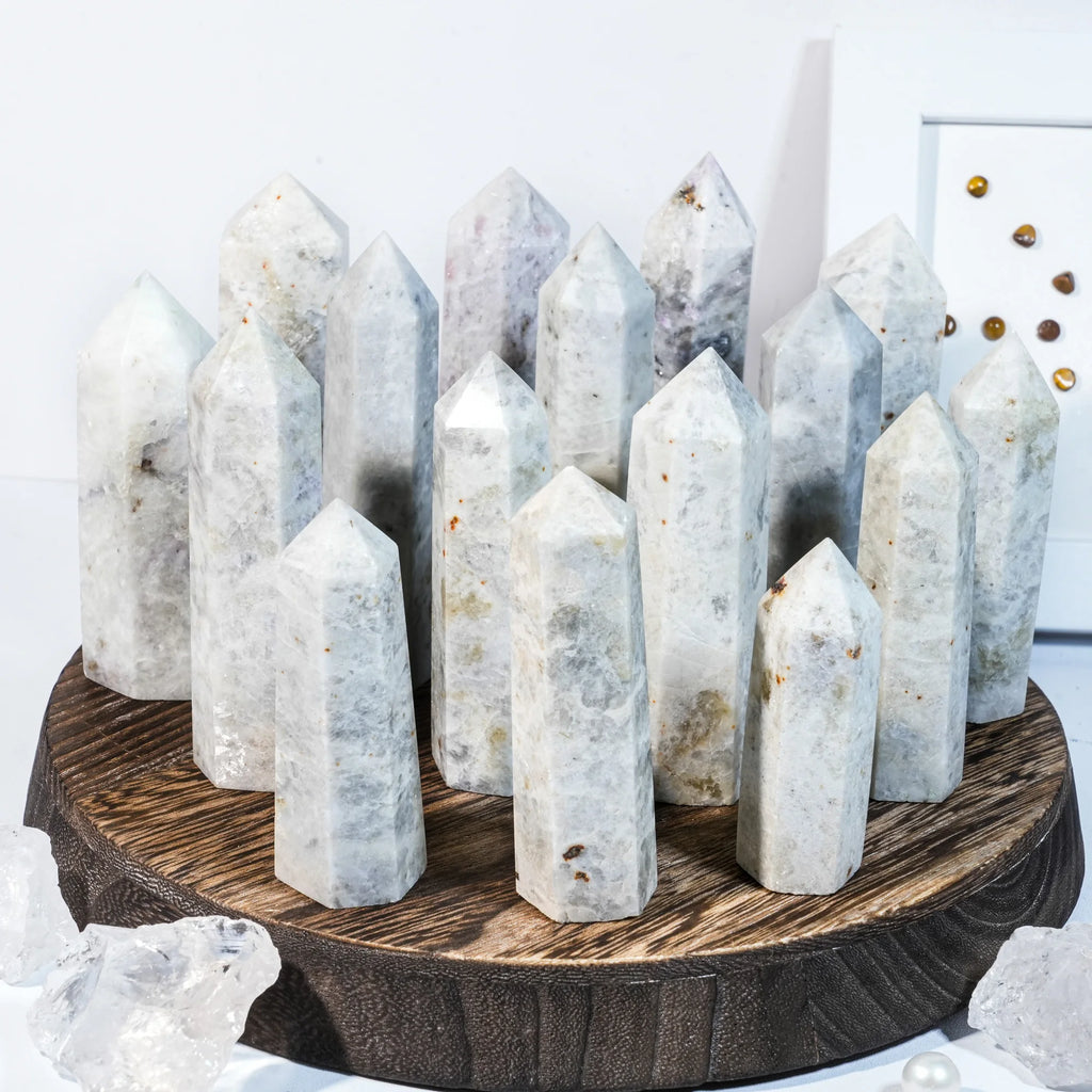 Natural gemstone crystal point tower with multiple tall pointed crystals on a round base.