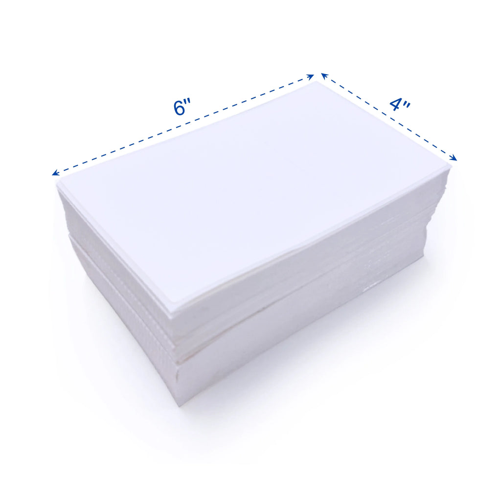Stack of white thermal label sheets, neatly folded and aligned