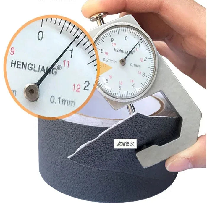 Black anti-slip tape roll with caliper measuring thickness on textured surface