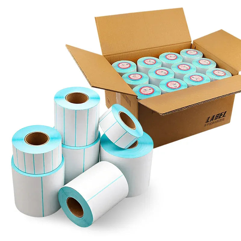 Thermal label roll and stacks of rolls in a shipping box, sky-blue edges