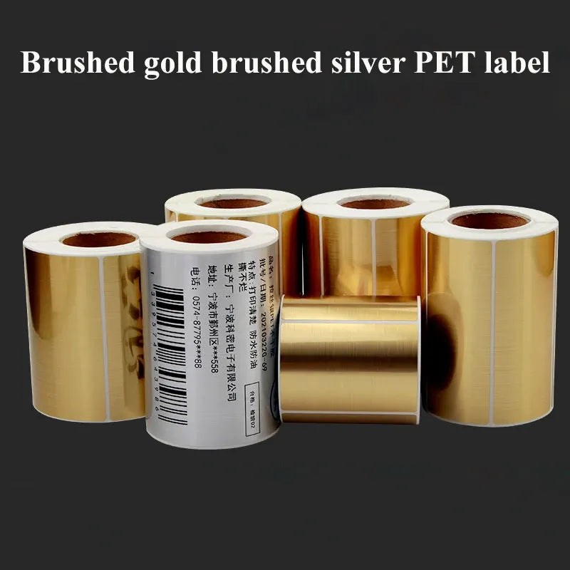 Brushed gold and brushed silver adhesive label rolls on cores, glossy PET film