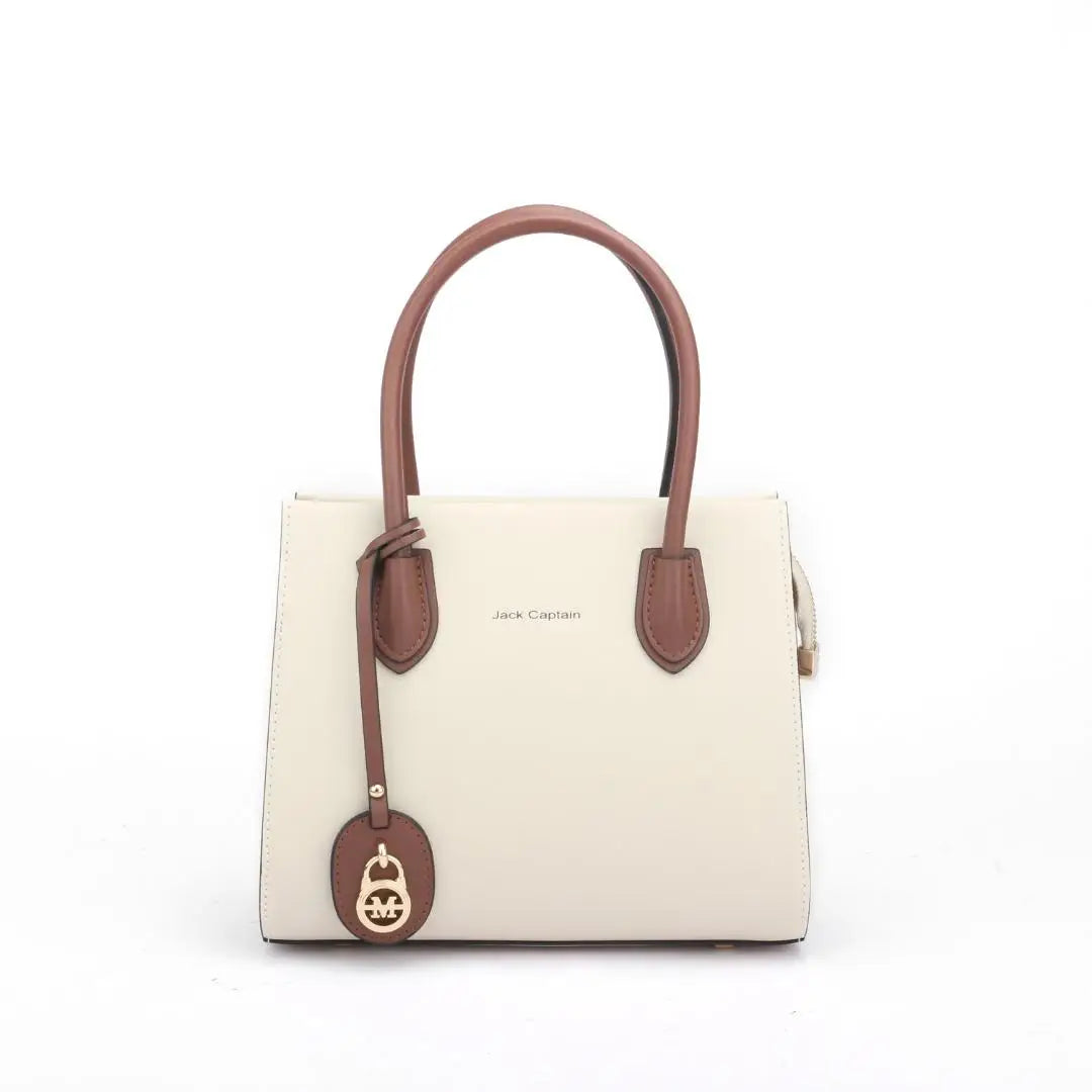 Jack Captain cream and brown leather designer tote handbag with elegant gold charm. Stylish structured shoulder bag.