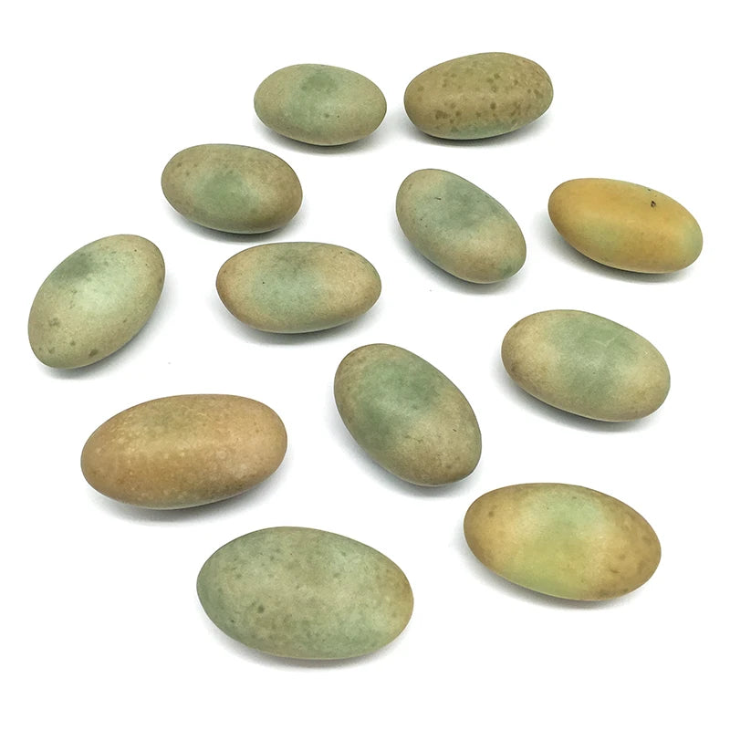 Set of green and yellow oval crystal pebbles, smooth luminous landscaping stones