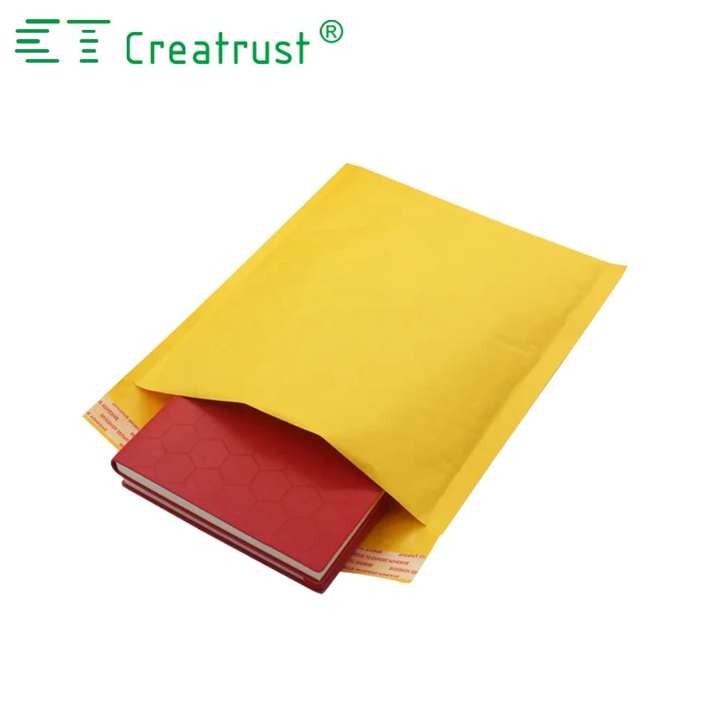 Yellow padded mailing envelope holding a red folder or booklet inside
