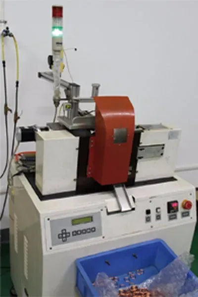 Desktop barcode scanner on industrial base with orange scan housing
