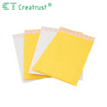 Yellow and white padded mailing envelopes stacked with fold-over flaps visible