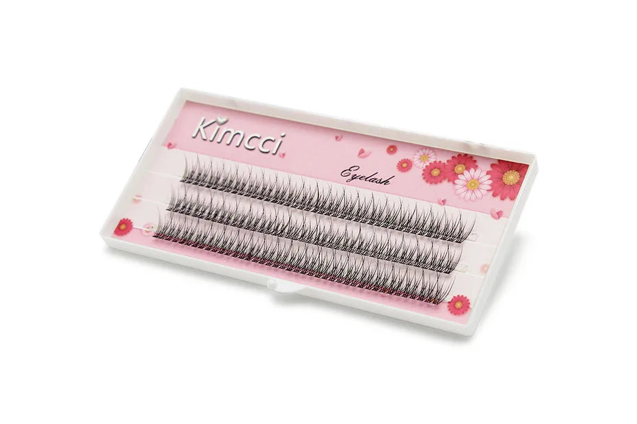 Kimcci individual 3D mink eyelash clusters in a white tray with a floral pink background.