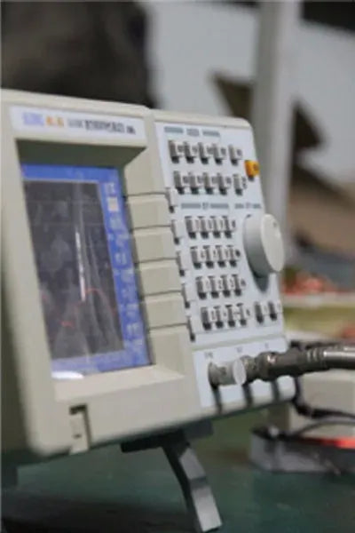 Close-up of barcode scanner control panel with buttons, screen, and scan module