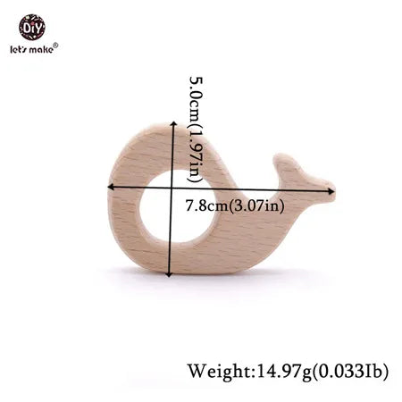 Whale-shaped natural wood baby teething toy for soothing gum pain.
