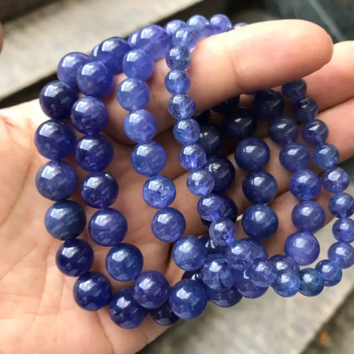 Blue round gemstone bead bracelet, tight strand view on hand