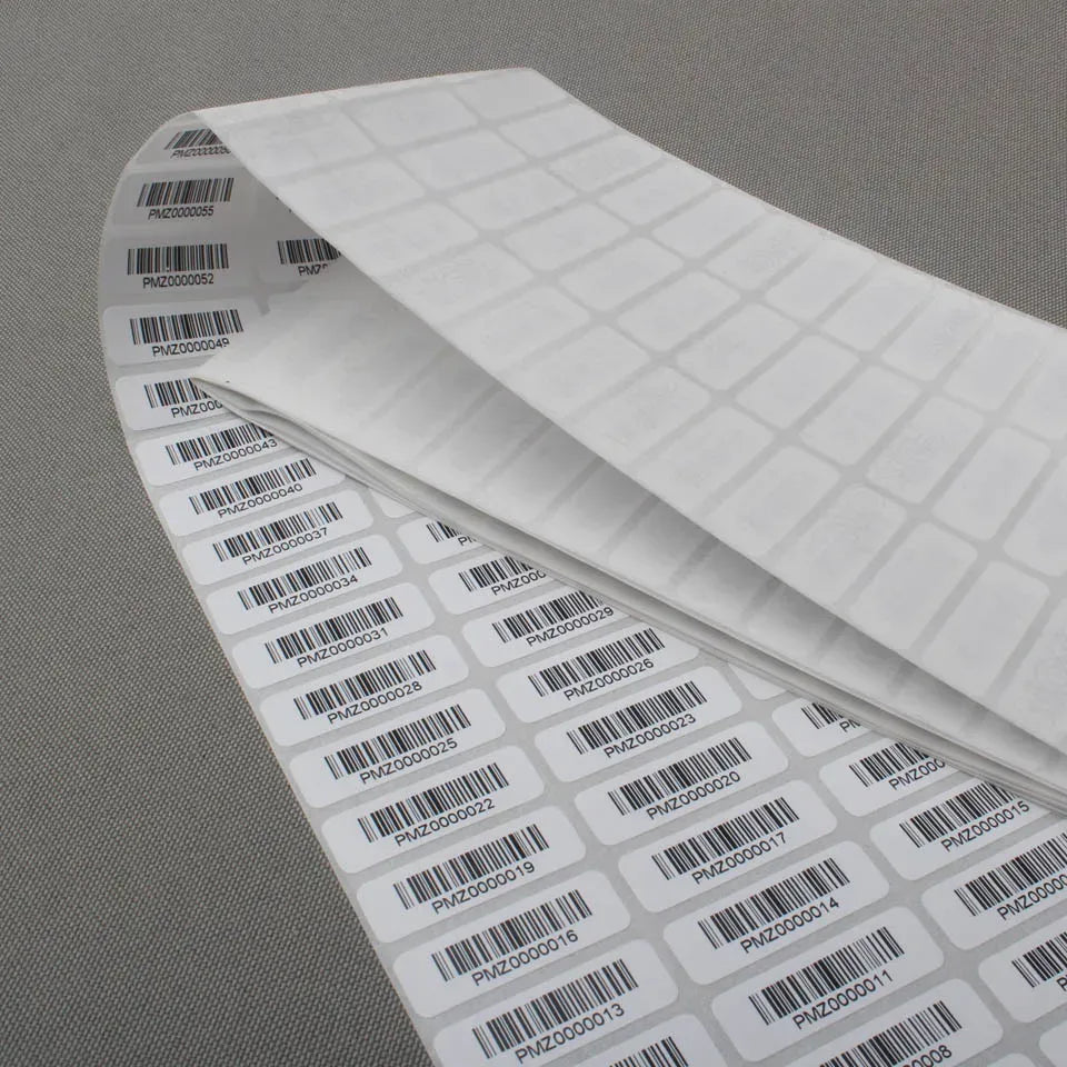 Rolled barcode sticker label roll with white adhesive labels and printed barcodes