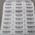 Barcode sticker label sheet with multiple white adhesive labels and barcodes