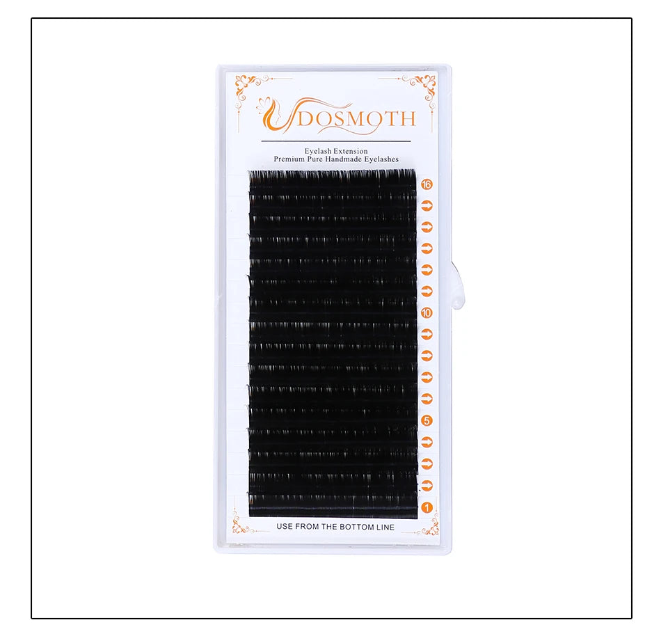 Black individual eyelash extension strips in a rectangular white tray with numbered rows for professional application.
