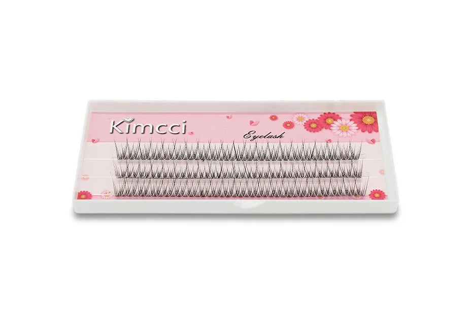Tray of 120 Kimcci premium black mink individual dovetail lash clusters on a pink floral background.