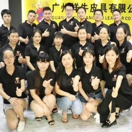 Professional team at Guangzhou Leather Co. producing luxury plaid leather messenger bags and trunks for wholesale.