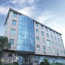 Modern multi-story office building with glass facade and many windows